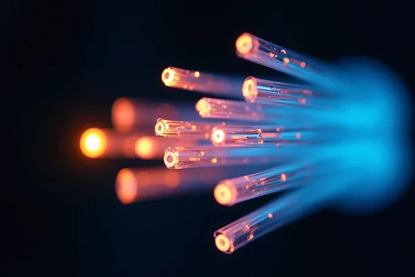 Close-up of fiber optic cables with visible light transmission, showing multiple colored strands against dark background