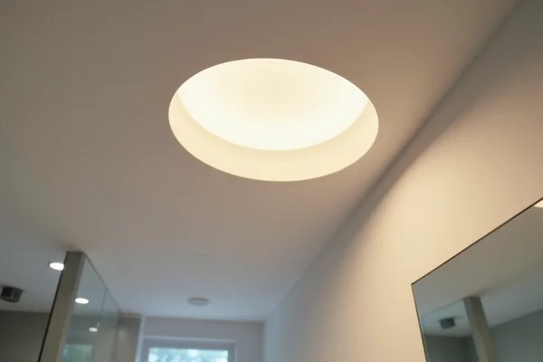 Close-up of recessed LED bathroom downlights being installed by electrician in ceiling