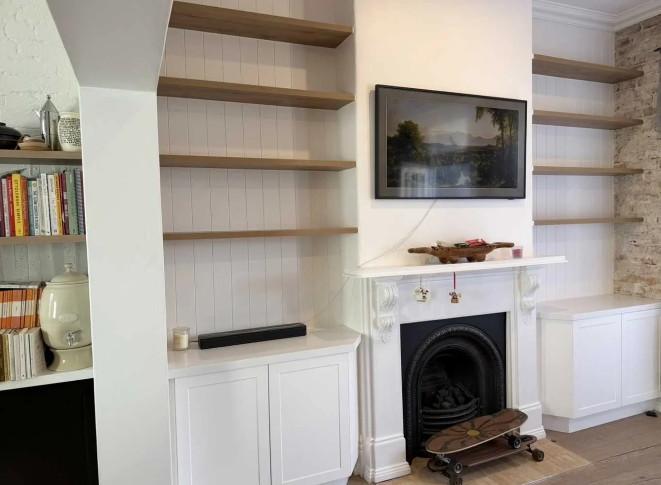 Heritage home restoration with custom curved shelving, exposed brick feature wall and restored Victorian fireplace by MTS Group
