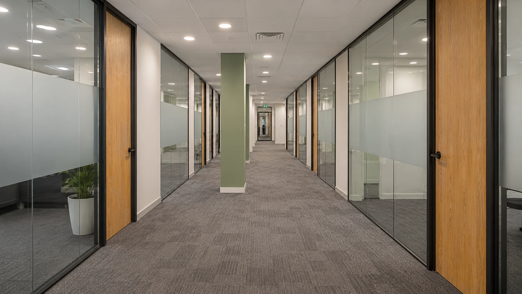 Maintained commercial building interior — office corridor with glass partitions