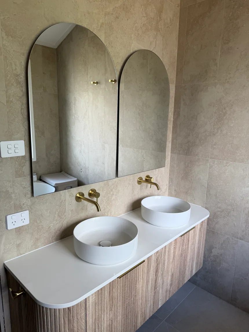 Bathroom renovation plumbing with twin basin vanity and brass tapware